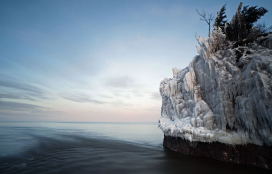 Ice covered rocks at the mouth of the Baptism river at twilight - Tettegouche State Park