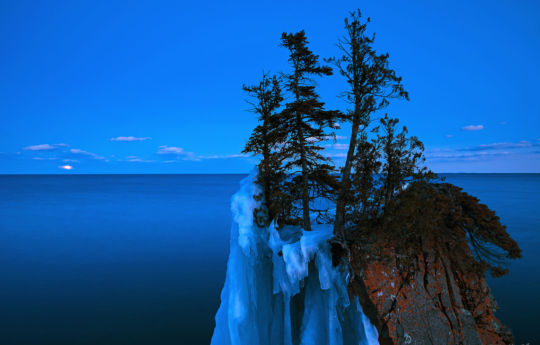 Full moon rising at Tettegouche State Park Fallen Arch and Lake Superior at twilight